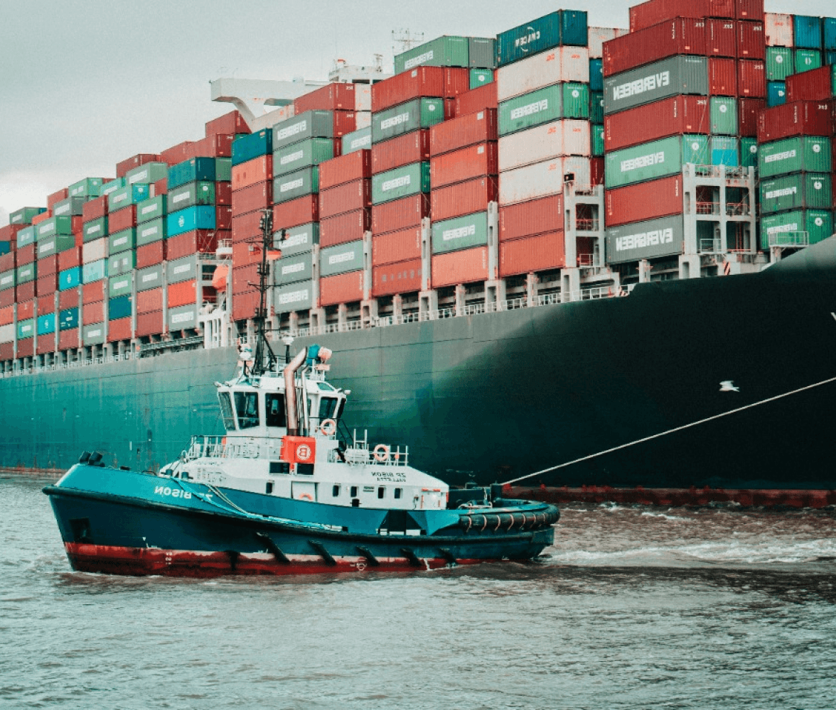 Tugboat towing a large container ship